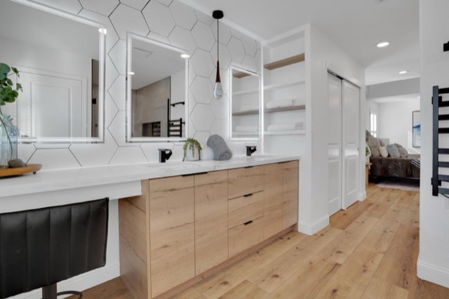 Open white kitchen with an island and hardwood floors