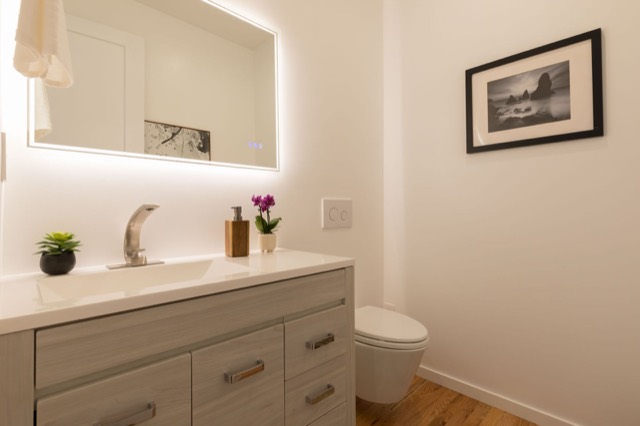 Bathroom vanity with a backlit mirror in a new unit