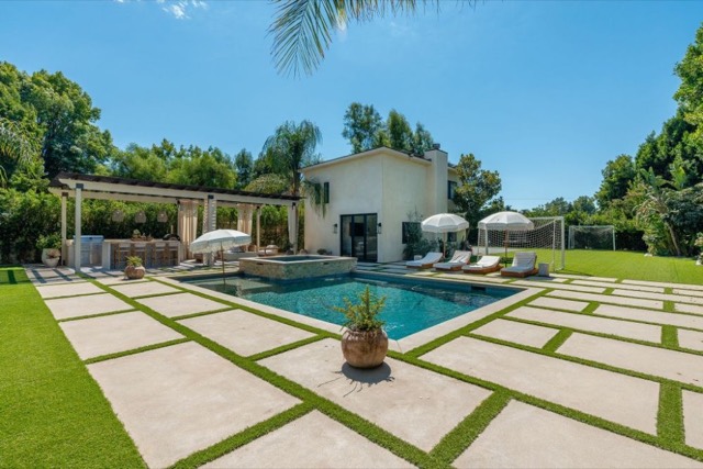 Pool and paver patio with lawn and seating