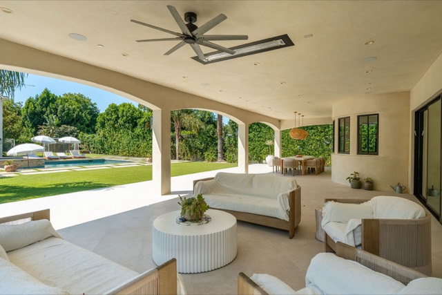Covered patio with outdoor seating and ceiling fan