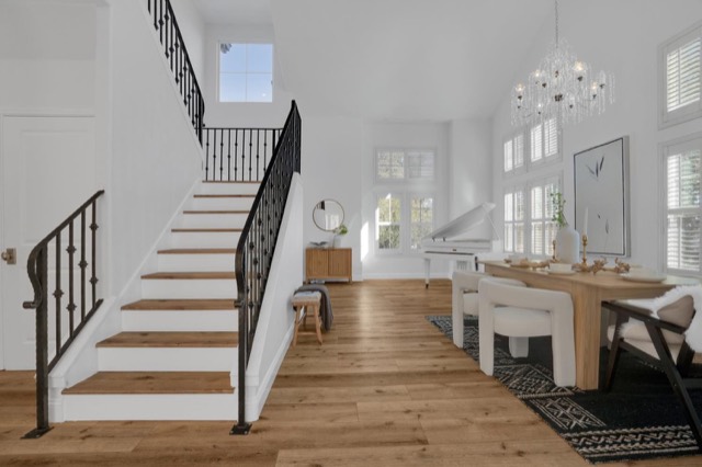 Staircase and open living space with hardwood floors