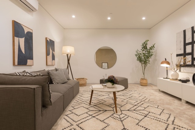 Living room of a new unit with neutral furniture