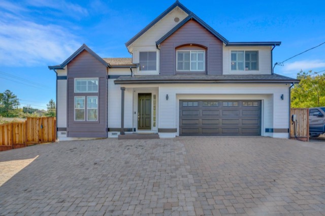 Two-story gray house with a pitched roof and garage