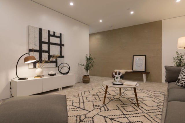 Living area in a new unit with a sofa and dining table