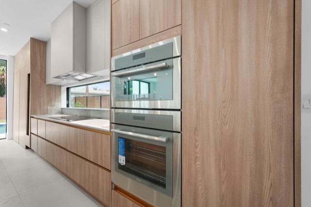 Wood cabinetry with built-in double wall ovens